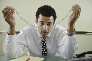 Businessman staring at paperclip chain